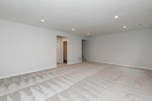 an empty living room with white walls and a tile floor at Two Rivers Home Rentals, West Des Moines, Iowa