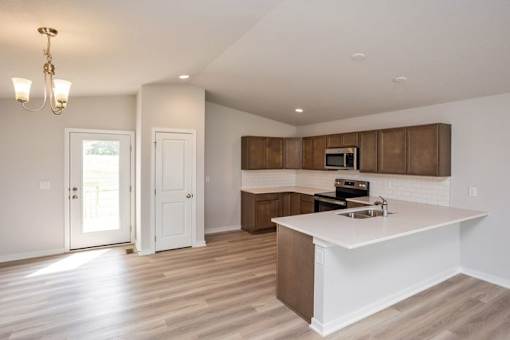 an empty kitchen with a white counter top at Two Rivers Home Rentals, West Des Moines