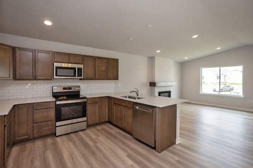 a kitchen with a stove and a sink at Two Rivers Home Rentals, West Des Moines, 50266