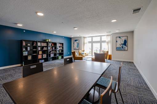 A conference room with a long table and chairs.