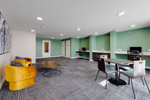 A room with a yellow chair and a table.