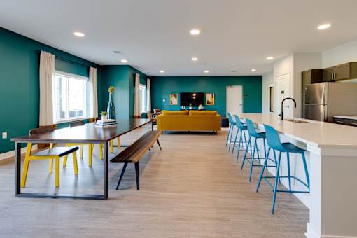 A kitchen with blue chairs and a table.