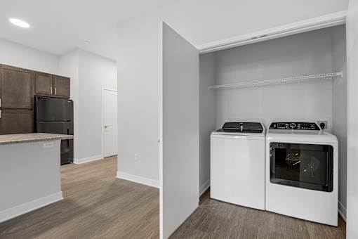 A kitchen with a white oven and microwave.