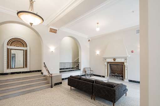 A large room with a fireplace and a couch.