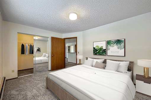 a bedroom with a large bed and a closet at Autumn Park, Sioux Falls  