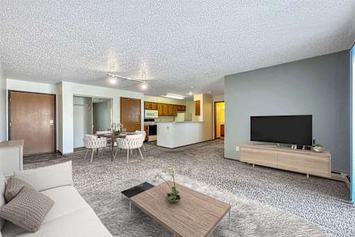 a living room with a couch and a tv at Autumn Park, Sioux Falls  