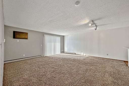 an empty living room with carpet and a ceiling fan at Autumn Park, Sioux Falls South Dakota  