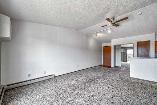 an empty living room with white walls and a ceiling fan at Autumn Park, Sioux Falls South Dakota  