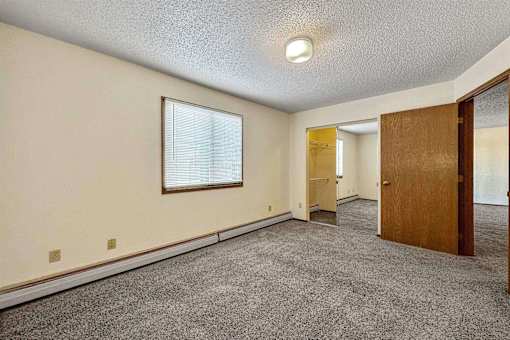 an empty living room with a door and a window at Autumn Park, Sioux Falls, SD  
