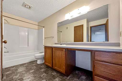 a bathroom with a sink toilet and a mirror at Autumn Park, South Dakota, 57106