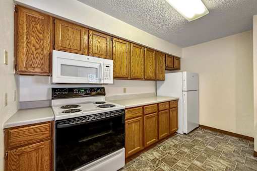 a kitchen with a stove microwave and refrigerator at Autumn Park, Sioux Falls, SD 57106  