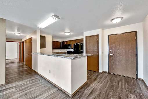a kitchen with a counter top and a refrigerator at Autumn Park, Sioux Falls, SD  