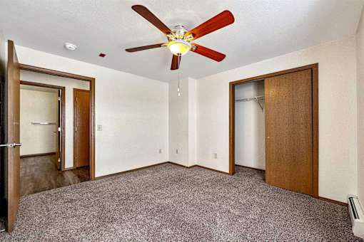 a bedroom with a ceiling fan and a closet at Autumn Park, South Dakota, 57106