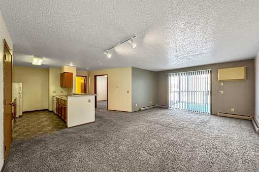 the living room and kitchen of an empty apartment at Autumn Park, Sioux Falls, 57106  