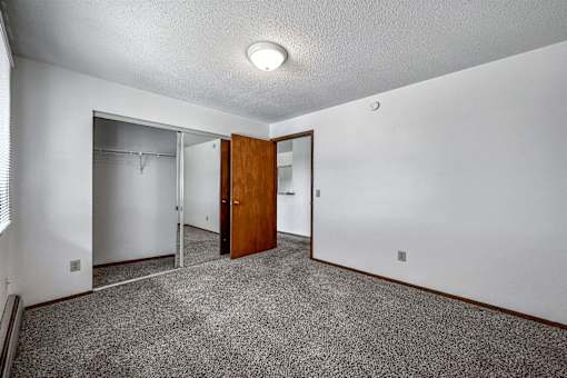 a room with carpet and a door to a closet at Autumn Park, South Dakota  