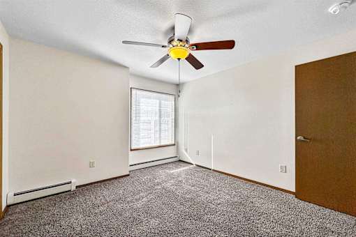 an empty room with a ceiling fan and a window at Autumn Park, Sioux Falls, 57106  