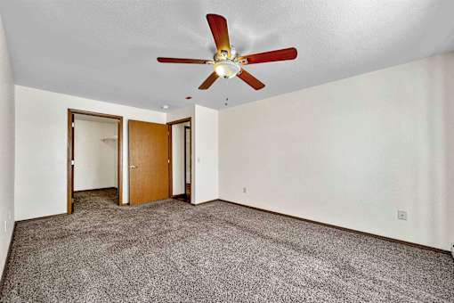 a living room with carpet and a ceiling fan at Autumn Park, Sioux Falls South Dakota  