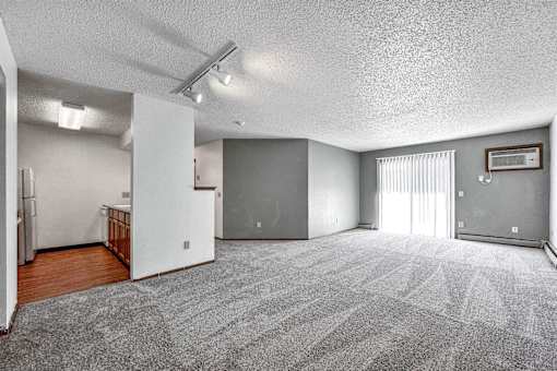 the living room is empty of furniture and has a sliding glass door at Autumn Park, Sioux Falls, SD 57106  