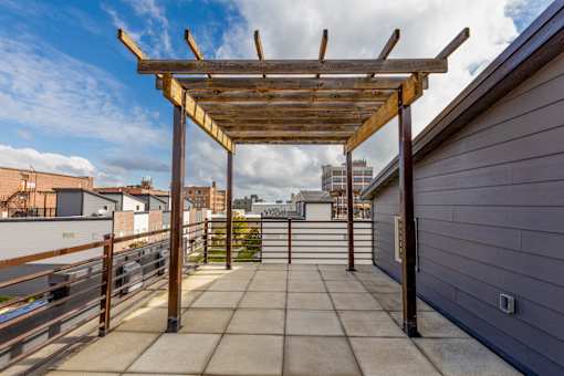 A wooden pergola on a rooftop patio.