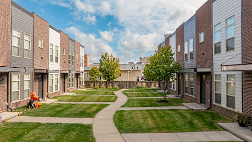 A residential area with apartment buildings and a green lawn.