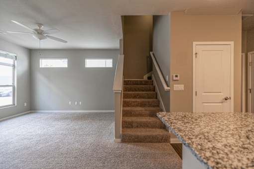 A room with a staircase leading to the second floor.
