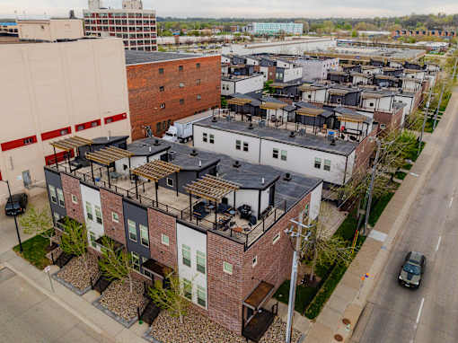 Apartment complex with a mix of brick and white buildings.