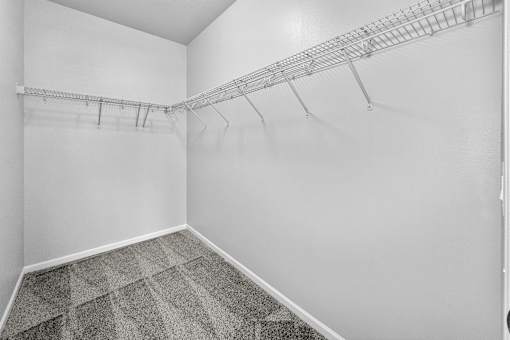 Empty room with a metal rack on the wall.
