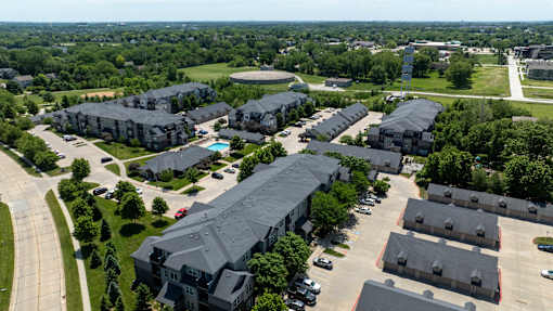 A large apartment complex with a swimming pool.