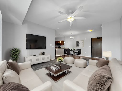 a white living room with couches and a coffee table at Stonegate Crossing Apartments, IOWA, 50325