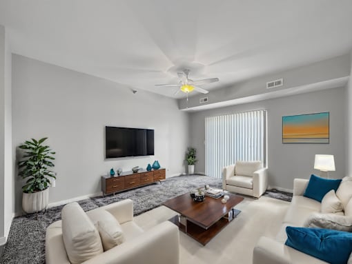 a living room with couches and a coffee table at Stonegate Crossing Apartments, IOWA