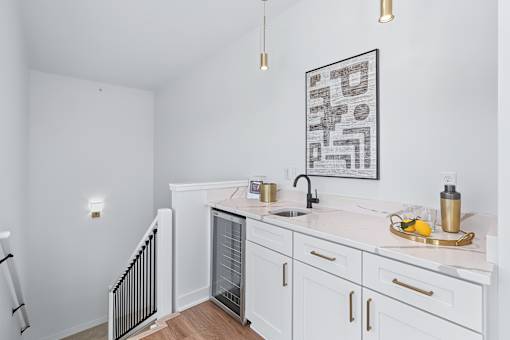 Upstairs wet bar with wine cooler and sink at The Flats at West Glen Apartments, West Des Moines, Iowa