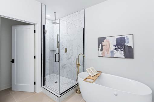 Spa bathroom with freestanding tub and glass shower at The Flats at West Glen Apartments, West Des Moines