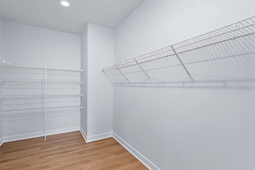 Walk-in closet with wire shelving systems at The Flats at West Glen Apartments, West Des Moines, IA 50266