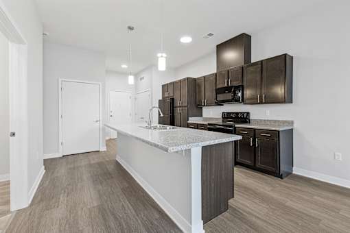 A modern kitchen with dark brown cabinets and a white island.