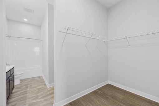 A white bathroom with a walk-in shower and a toilet.