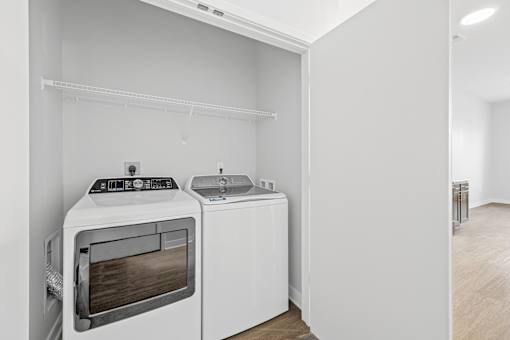 A white oven and dishwasher in a kitchen.