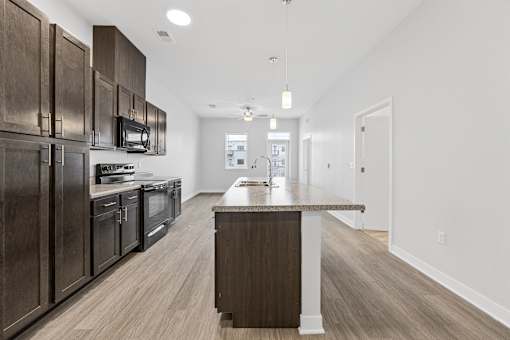 A modern kitchen with dark wood cabinets and a central island.