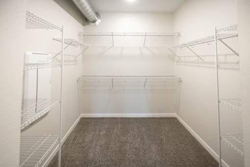 a spacious room with mirrored walls and empty closet space at Velocity Apartments, Des Moines, IA