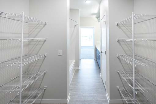 an empty closet in a room with white walls and white floors and a white door at Velocity Apartments, Des Moines, Iowa
