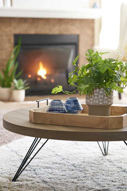 a living room with a coffee table and a fireplace at The Winhall of Williams Pointe Apartments, Waukee, 50263
