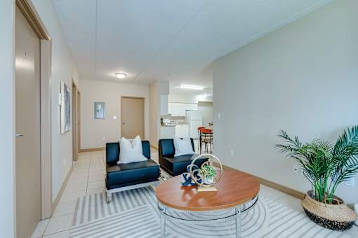 A living room with a blue couch and a wooden coffee table.