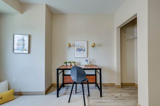 A room with a desk and chair in it.
