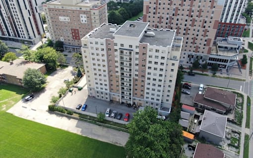 A large building with a parking lot in front of it.