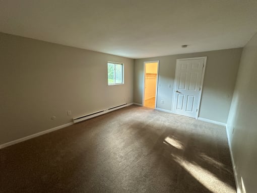 a bedroom with a door and a window