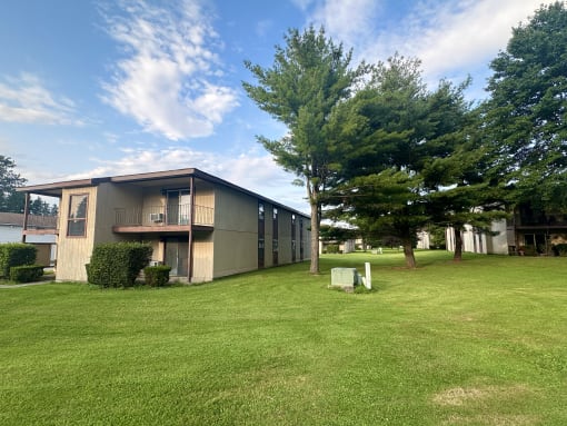 a building with a lawn and trees