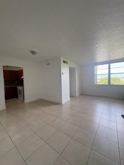 A room with white walls and a tiled floor.