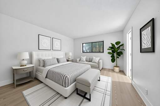 A bedroom with a large bed and a couch.