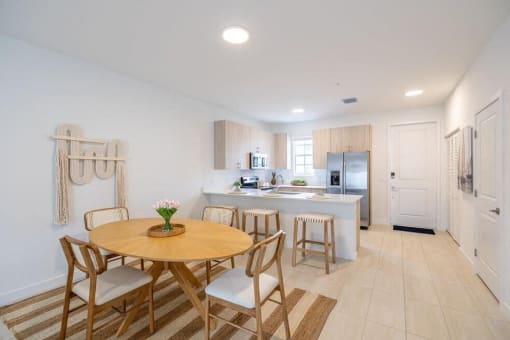 a kitchen and dining room with a table and chairs