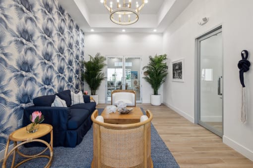 A living room with a blue and white wallpaper and a blue couch