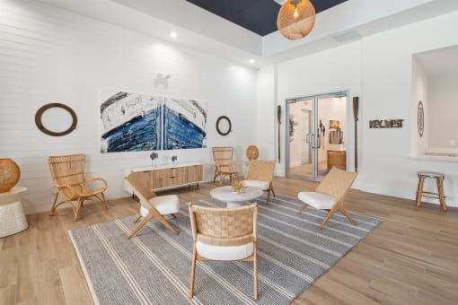 A living room with a couch and chairs and a table